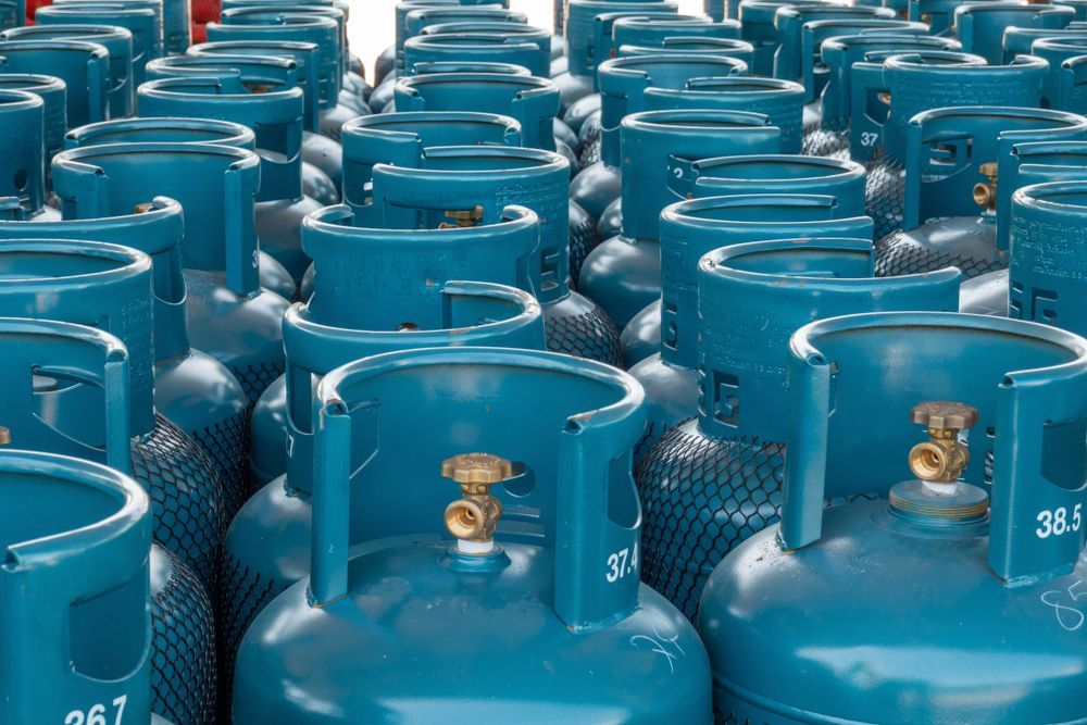 Rows of Teal Propane Tanks with Brass Valves — Lakeside Gas Fridges In Cessnock, NSW
