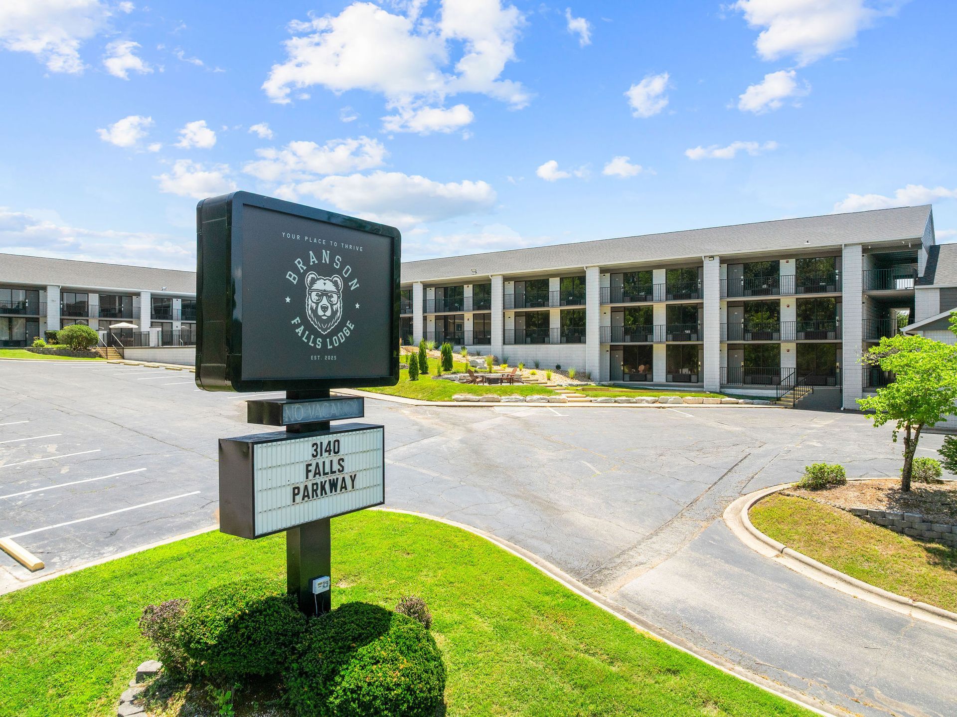 A large building with a sign in front of it.