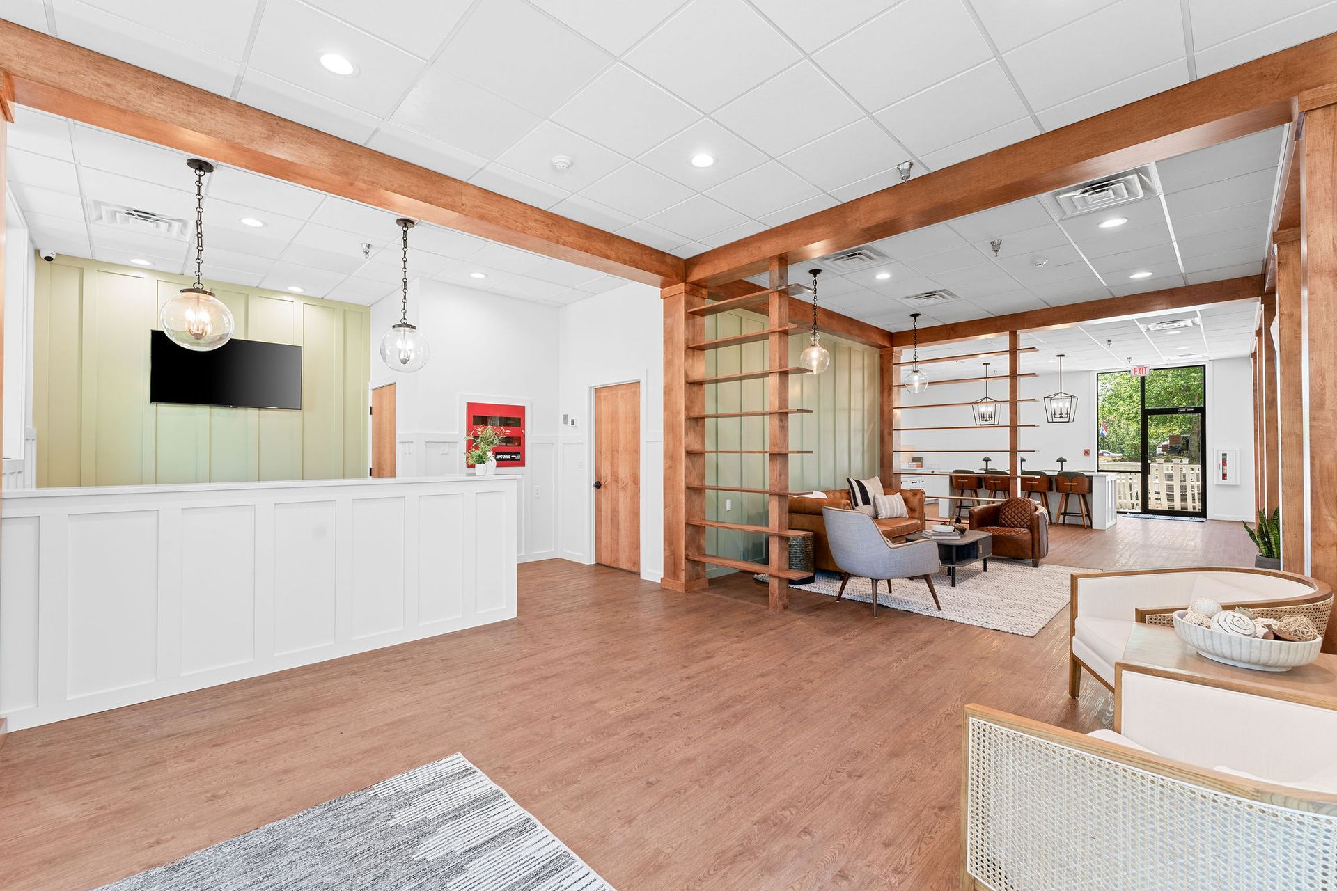 A large room with a wooden floor and a white counter.