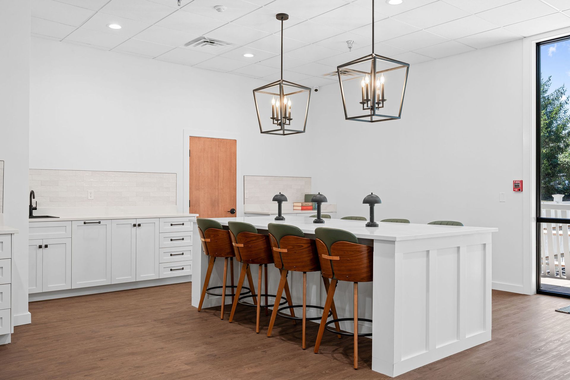 A kitchen with a large island and a lot of chairs.