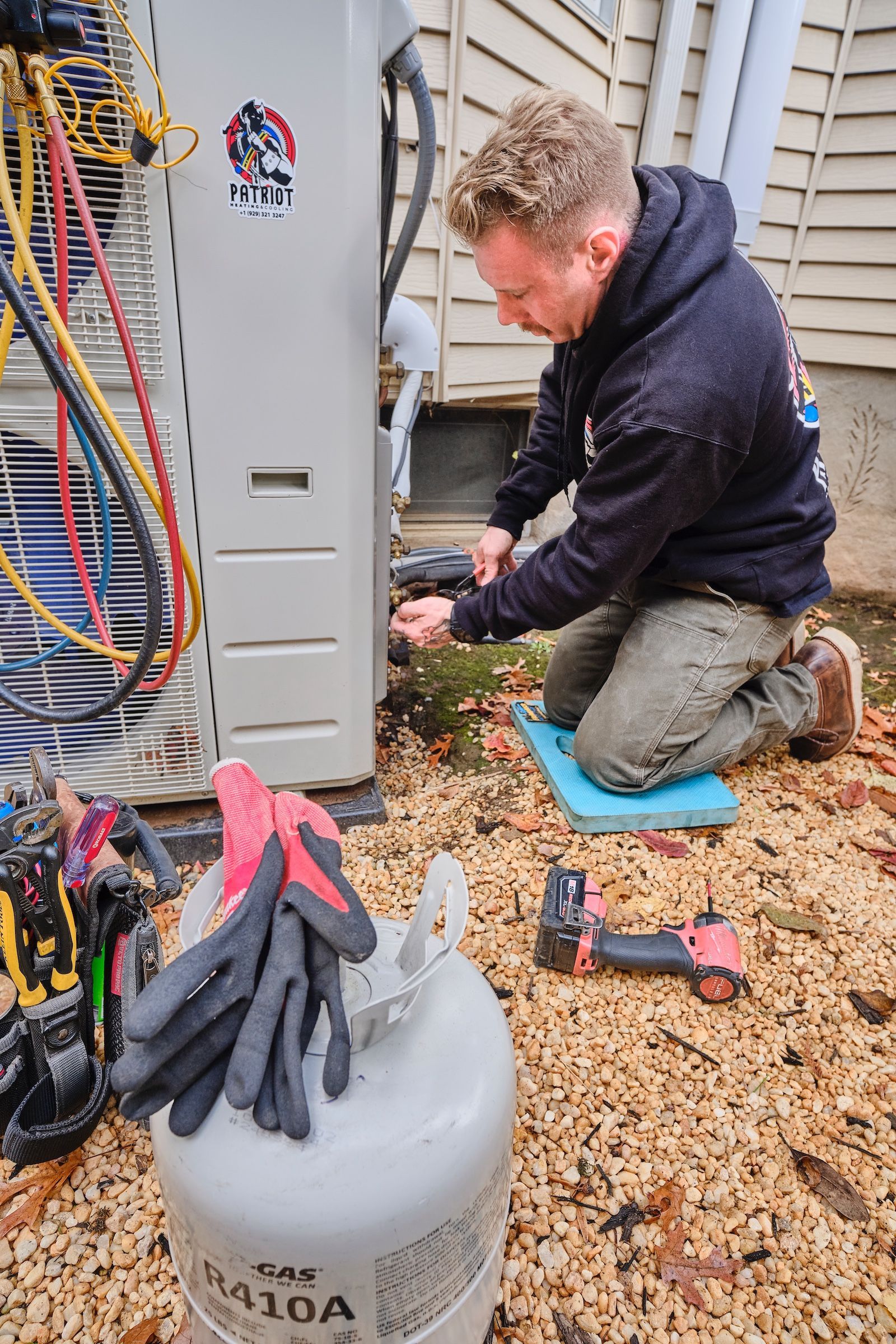 Electrician working on a circuit breaker panel in a residential setting.