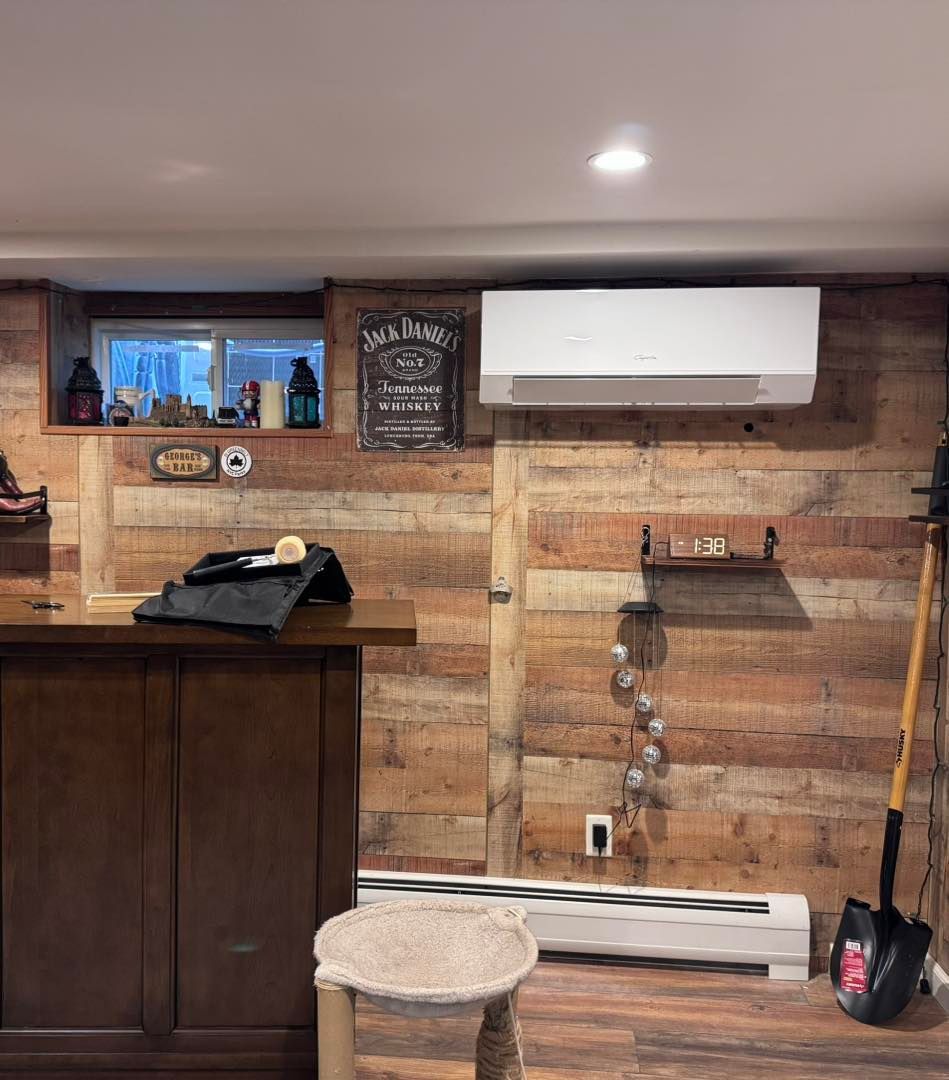 A basement with a wood-paneled wall, bar, and air conditioning unit.
