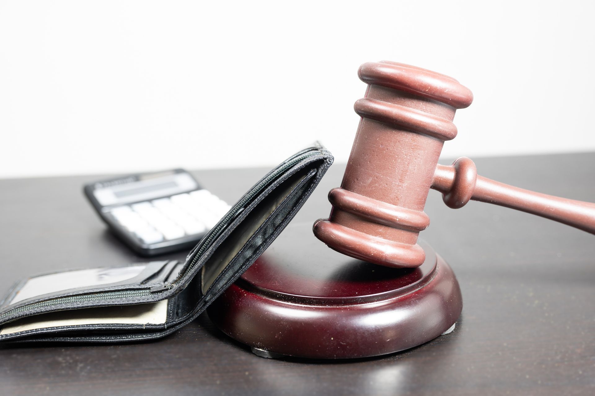 Judge's gavel with an empty wallet.
