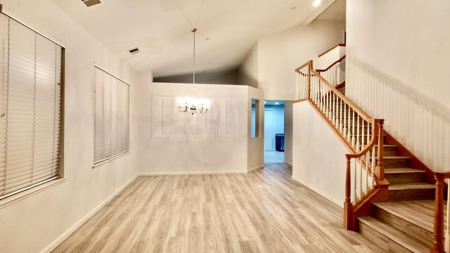 A ladder with a paint roller and tray on it in a room.