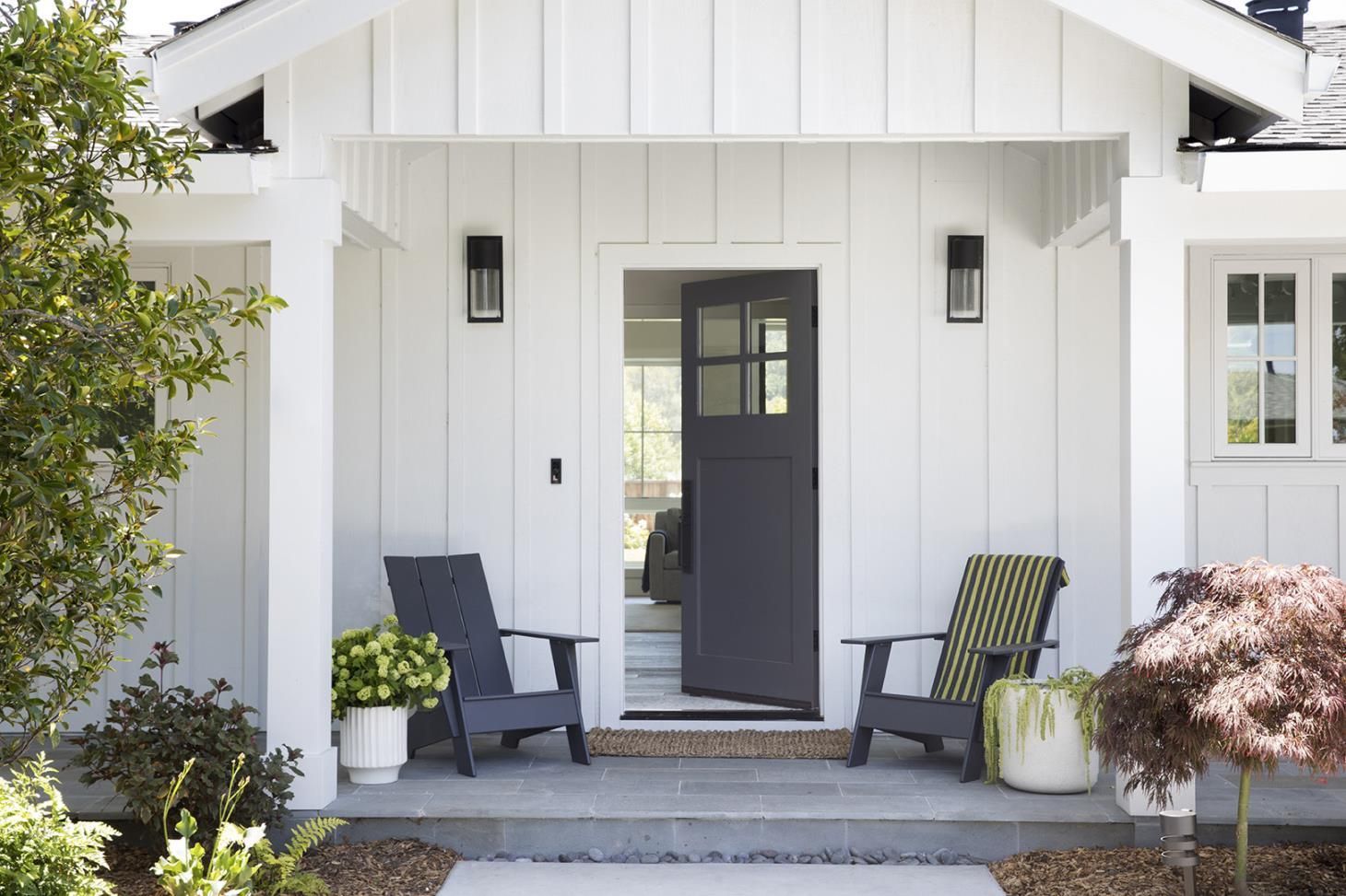 A person is painting a white door with a brush.