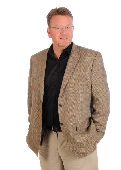 Man in blazer with hands in pockets, smiling.