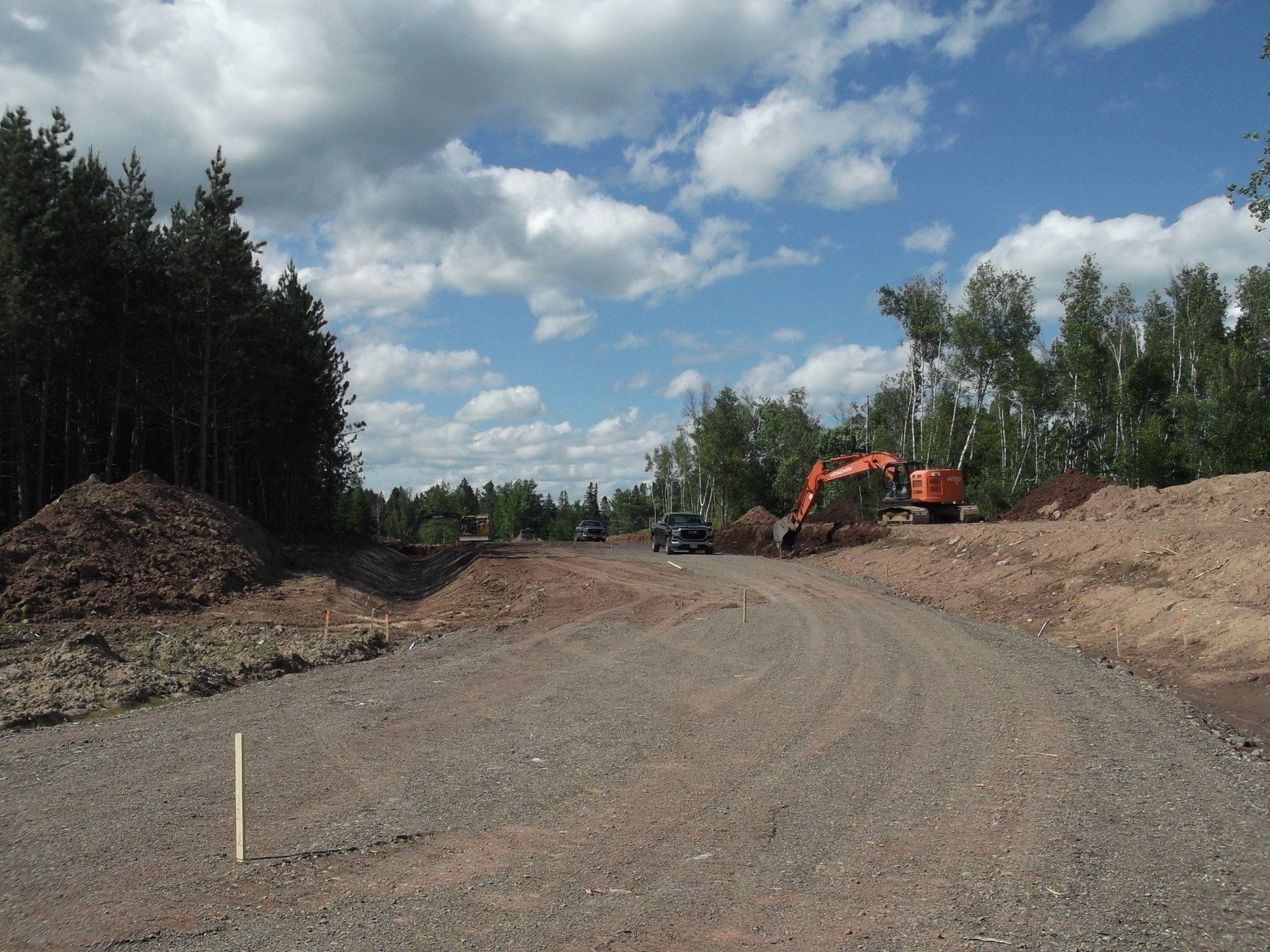 A dirt road with trees on the side of it