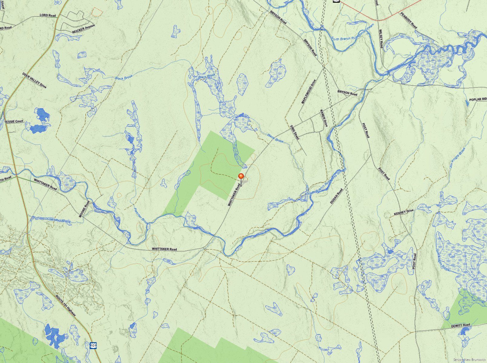 Map of a rural area with a river winding through it, roads, forests, and lakes. Red marker.