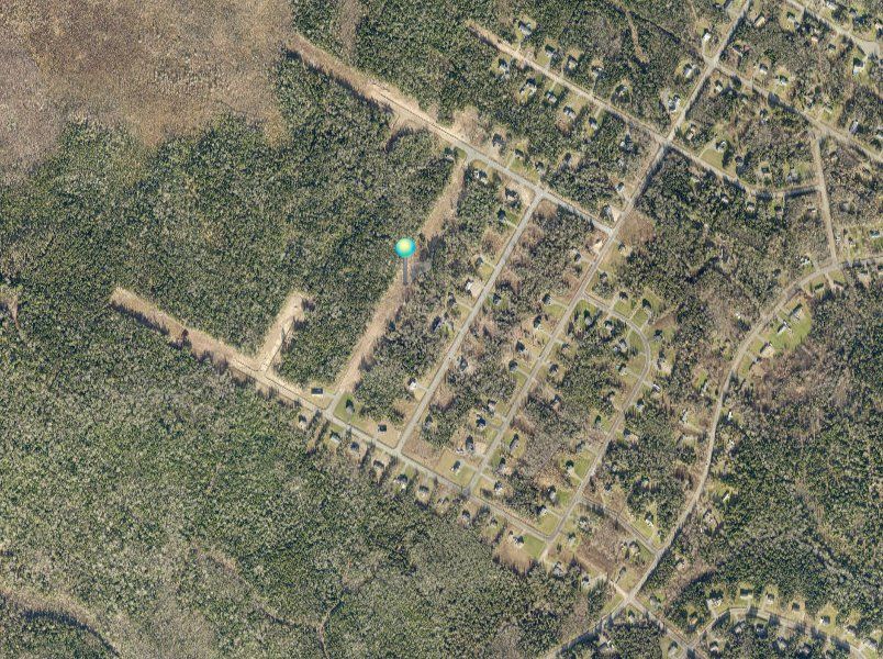 An aerial view of a residential area surrounded by trees.