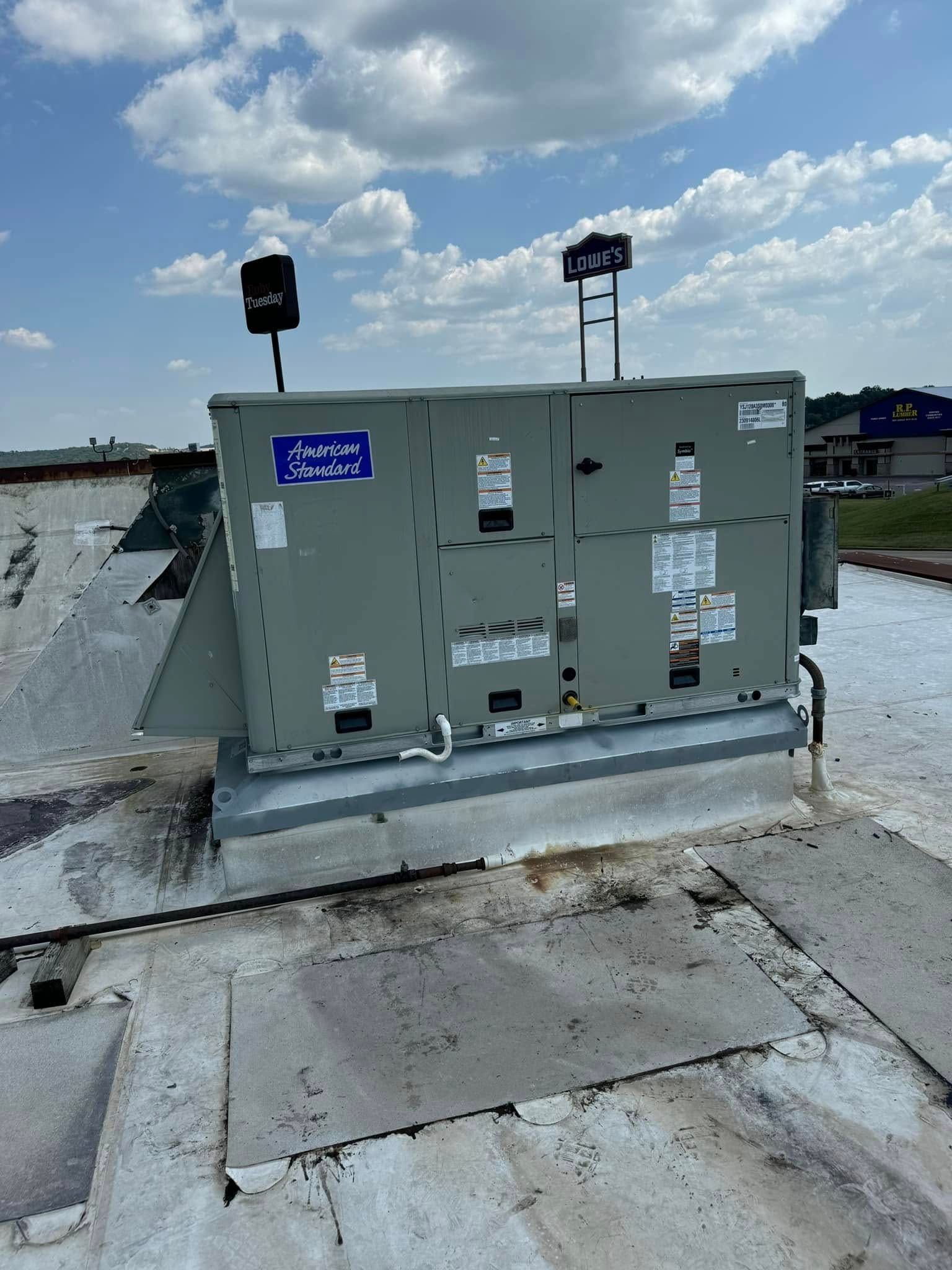 A large box is sitting on top of a roof.