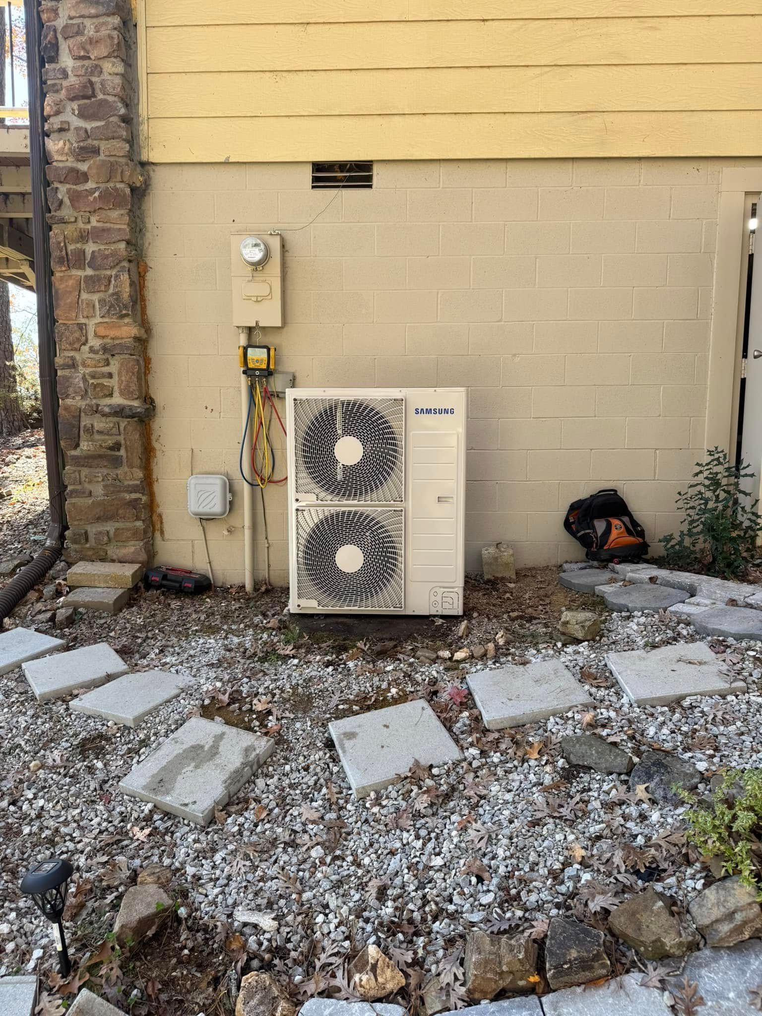 A large air conditioner is sitting on the side of a building.