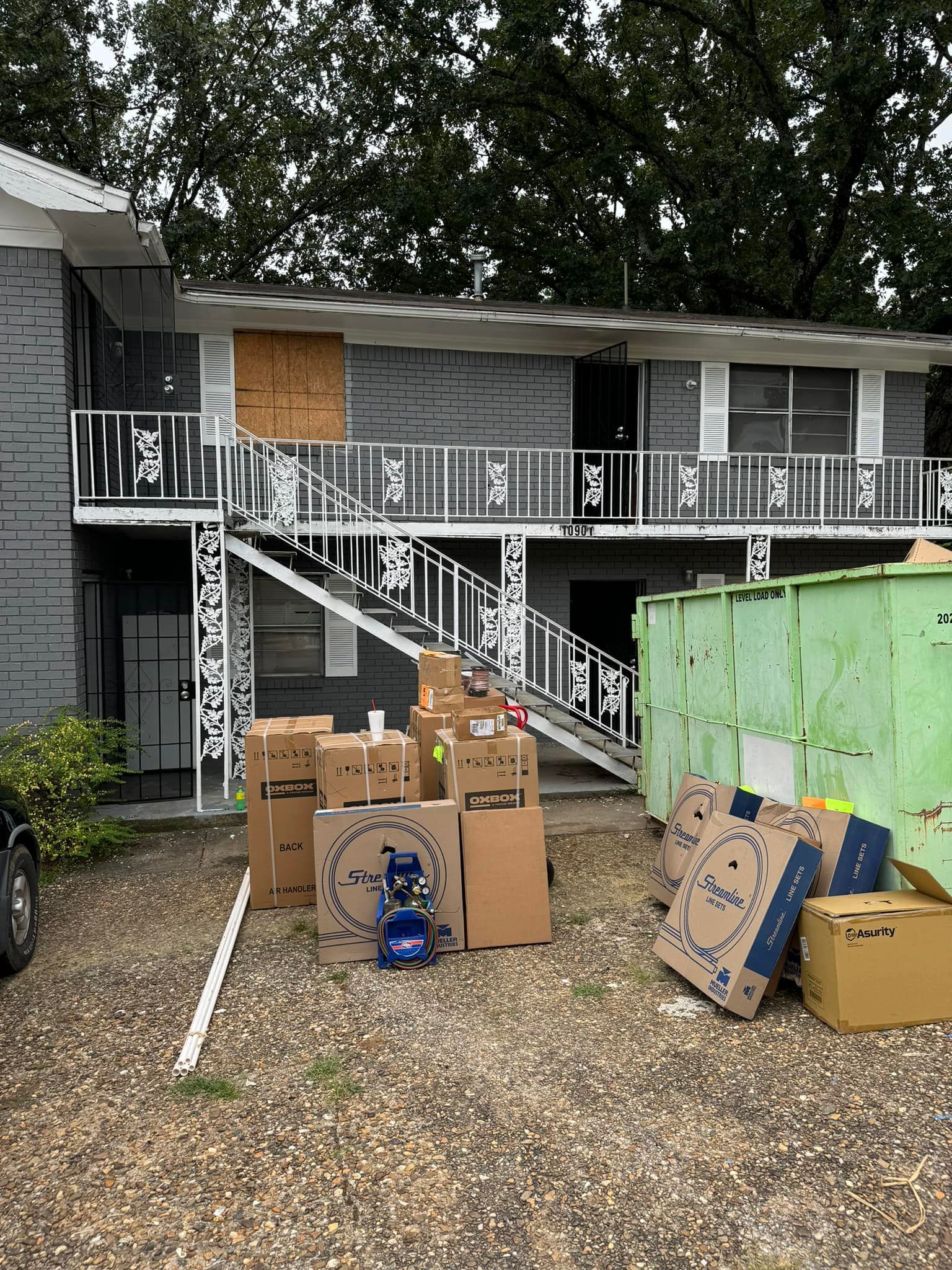 A bunch of cardboard boxes are sitting in front of a building.