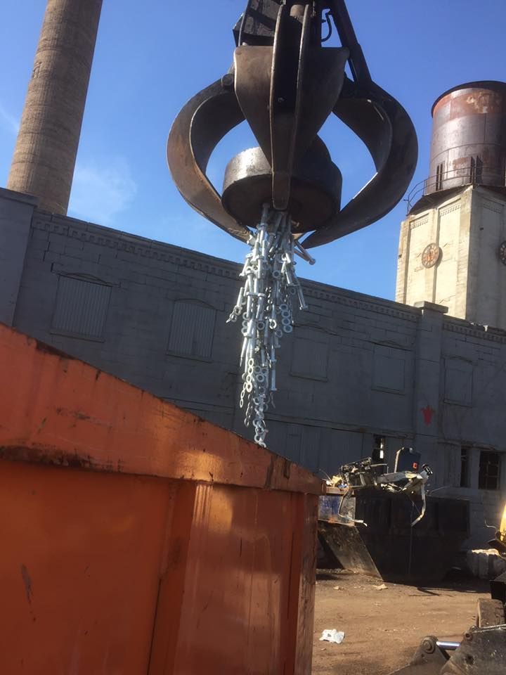 A large metal object is being lifted by a crane.