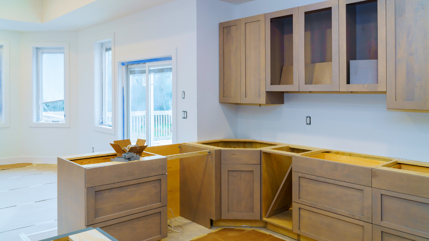 A kitchen under construction with wooden cabinets and drawers.