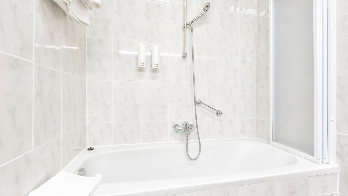 A bathroom with a bathtub and a shower stall.