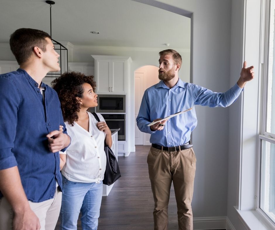 Realtor showing property to young couple