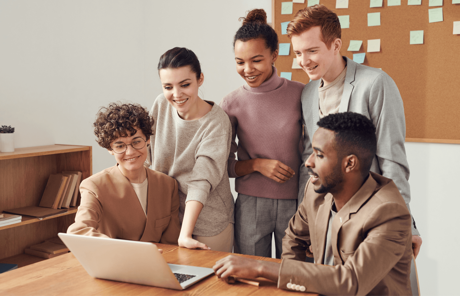 A group of people are looking at a laptop computer.