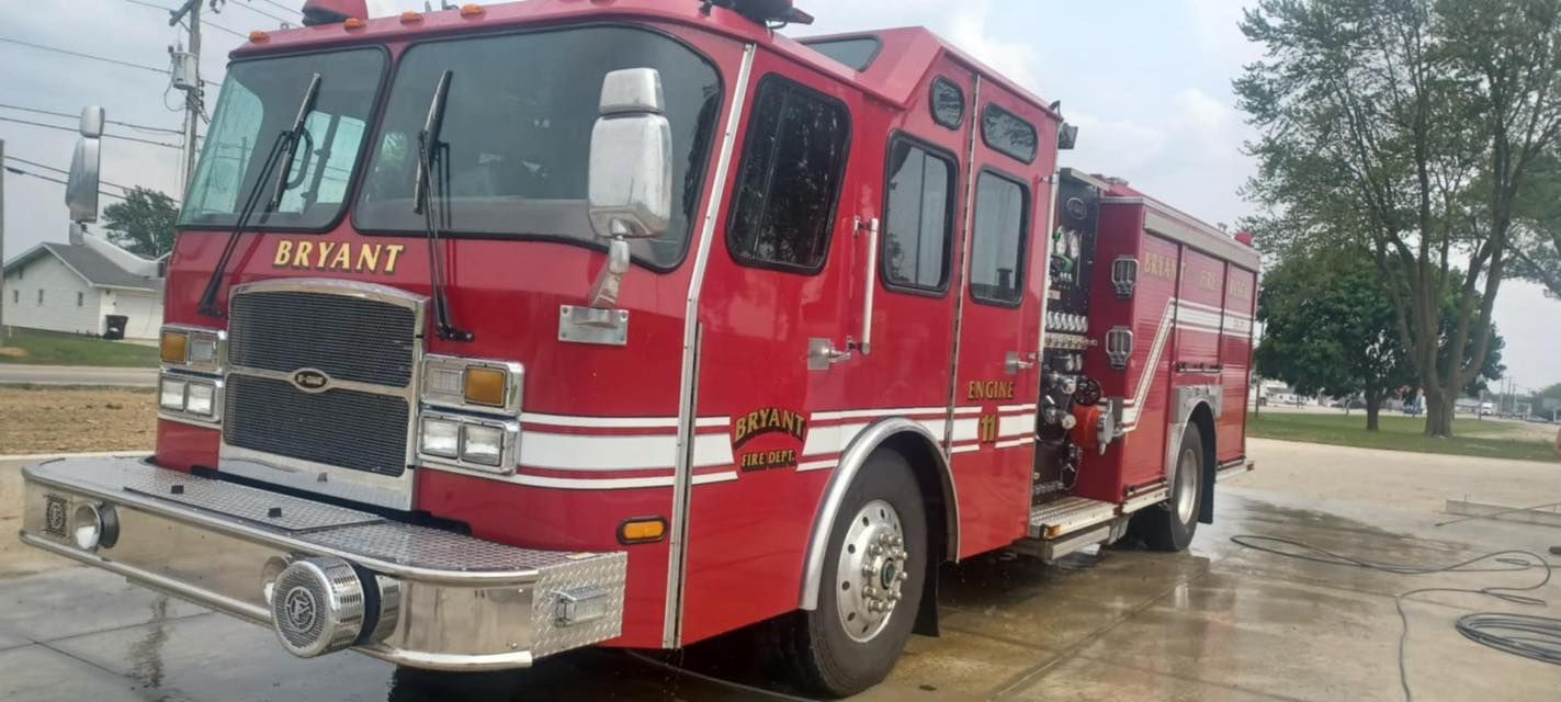 A red fire truck is parked on the side of the road.