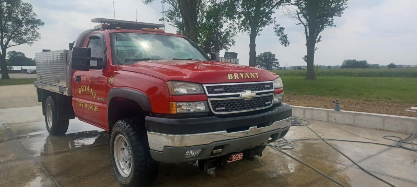A red tow truck is parked in a parking lot.
