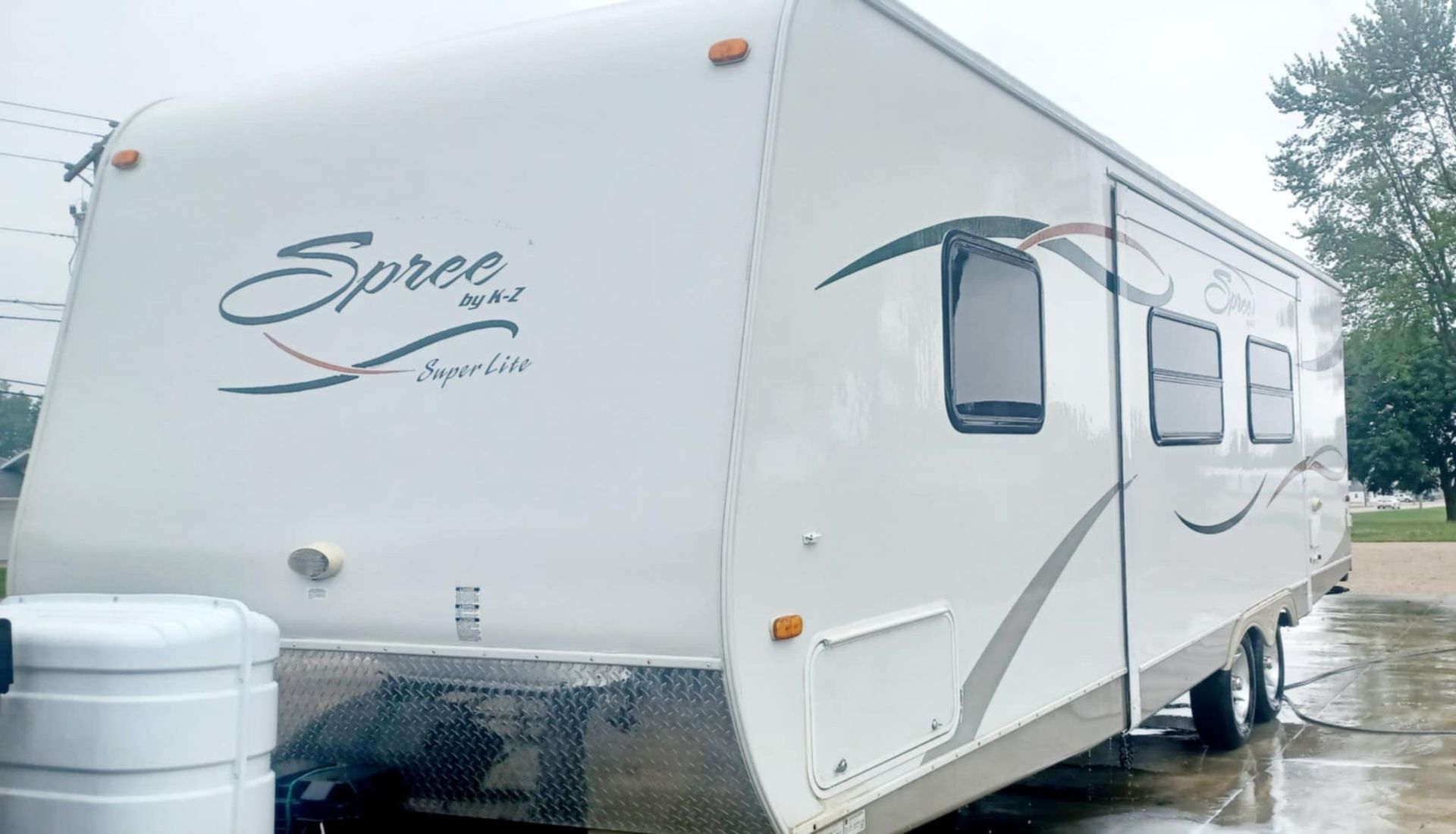 A white rv is parked in a parking lot.