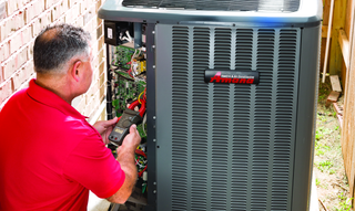 Air Conditioning — Technician Repairing Air Conditioner in Creve Coeur, IL