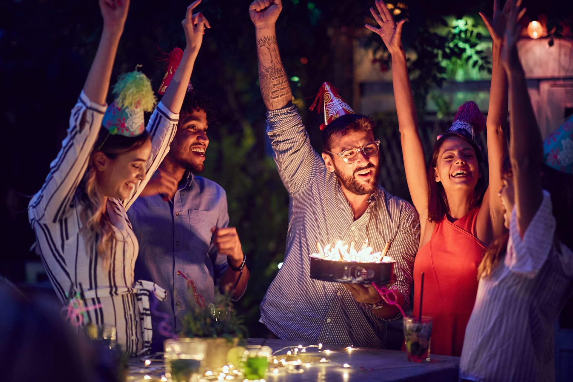 A group of people are celebrating a birthday with a cake.