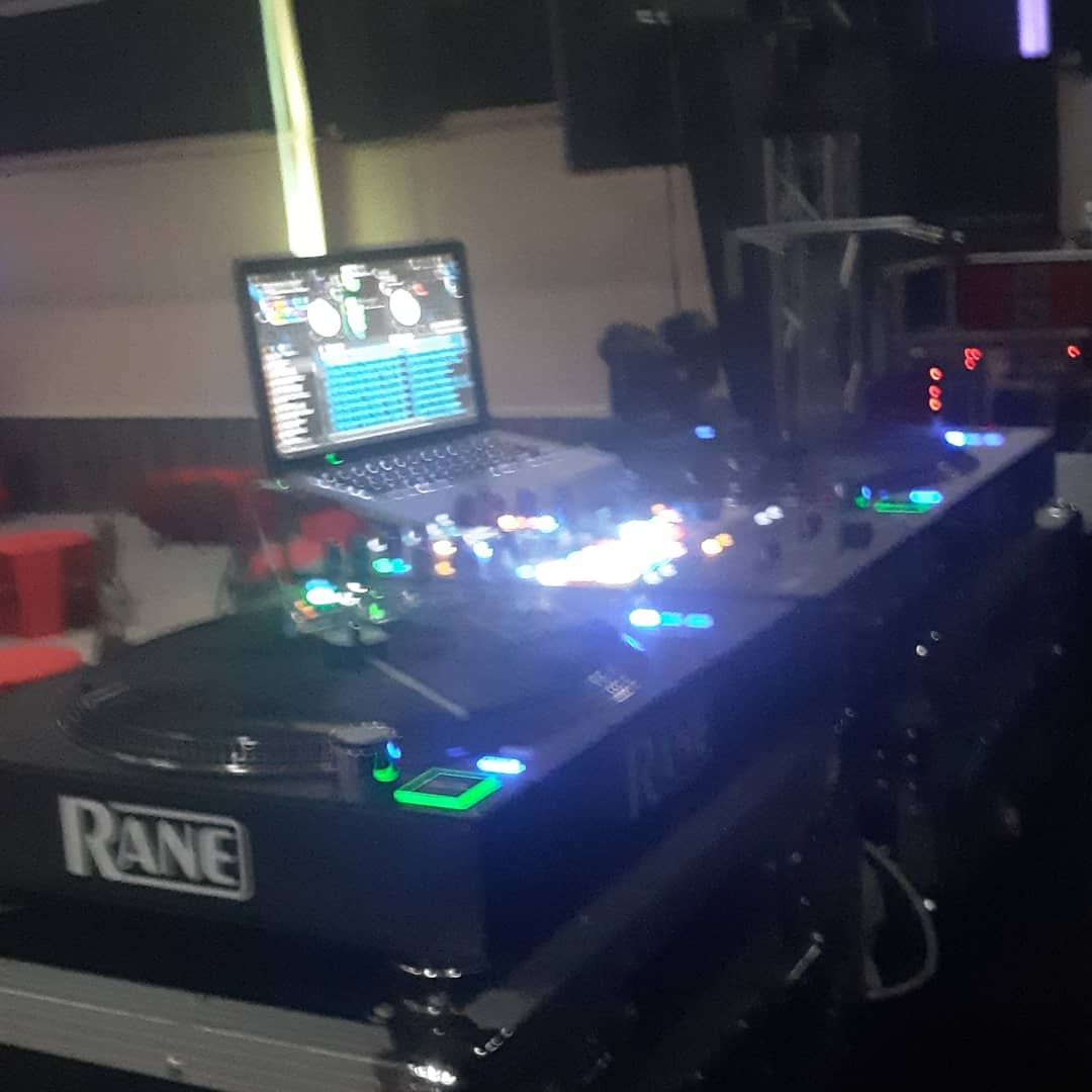 A laptop sits on top of a table that says rane