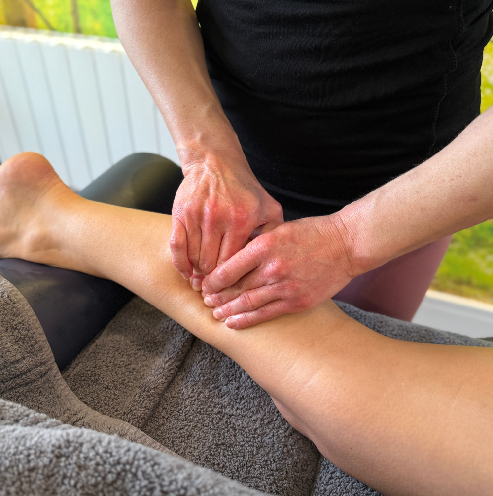 A woman is getting a massage on her leg