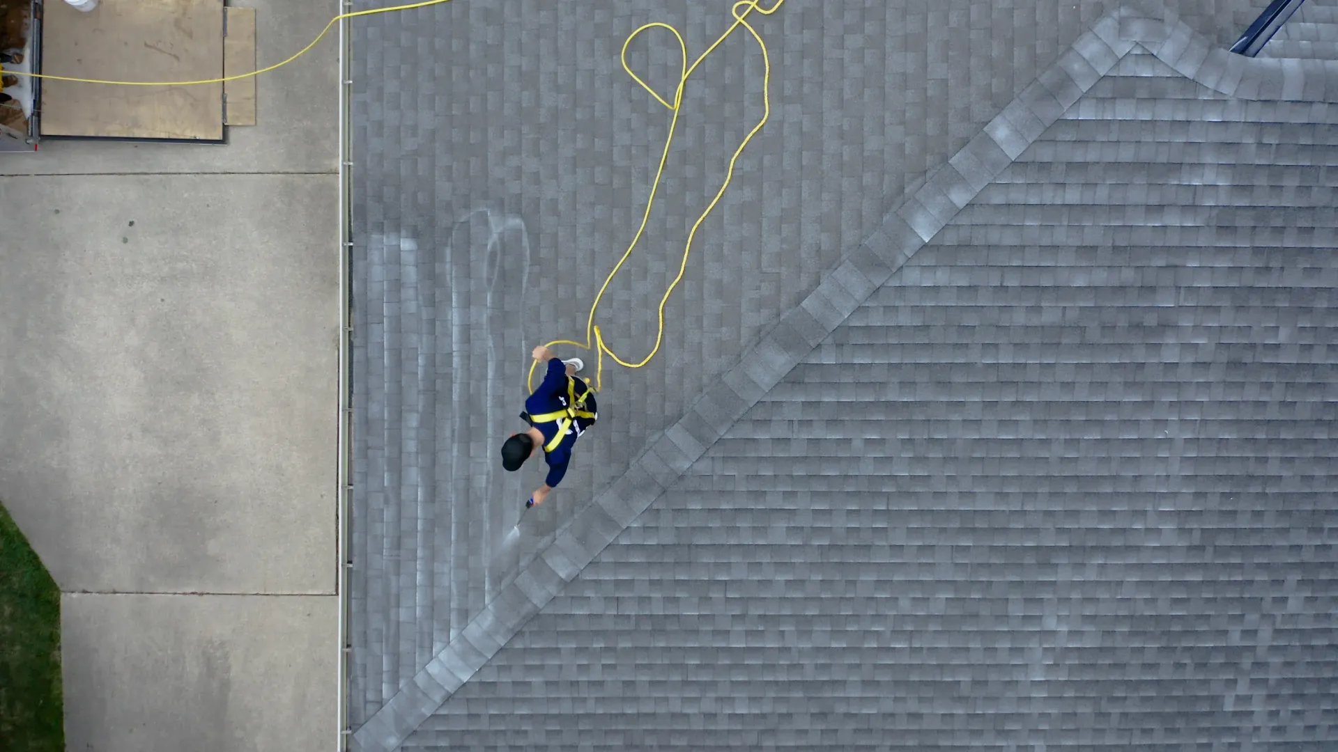 An aerial view of a man standing on top of a roof.