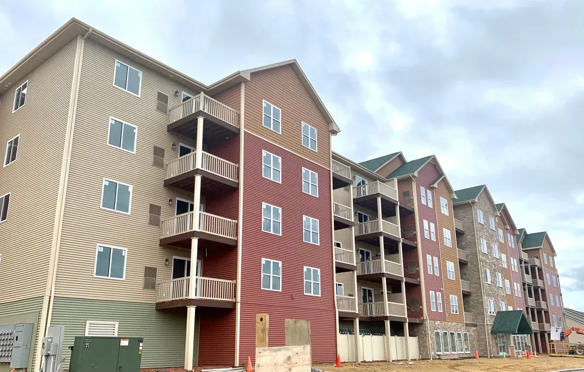 A large apartment building under construction with a lot of windows.