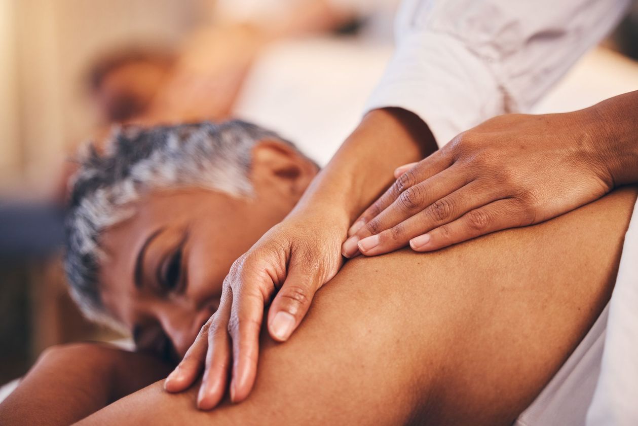 A woman is giving a man a massage in a spa.