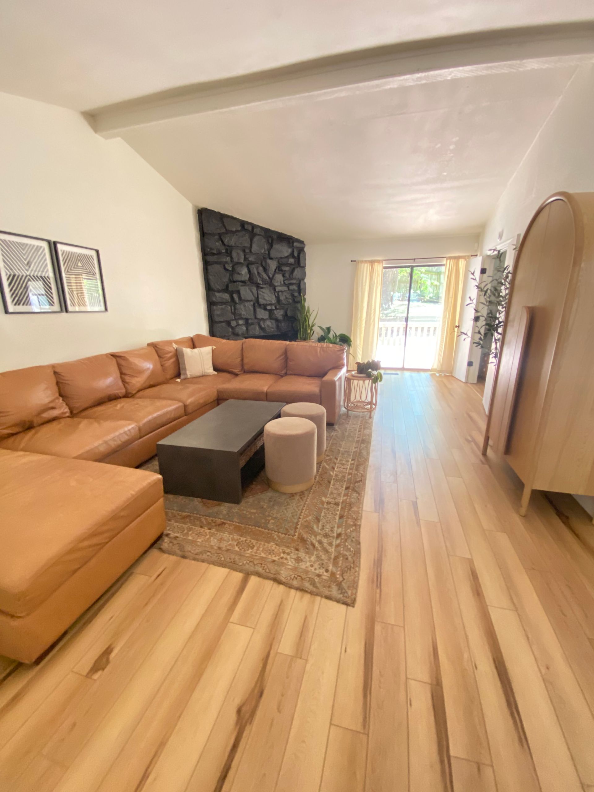 Staged living room with leather couch. Picture shows the worth of staging and how the house could sell faster if staged.
