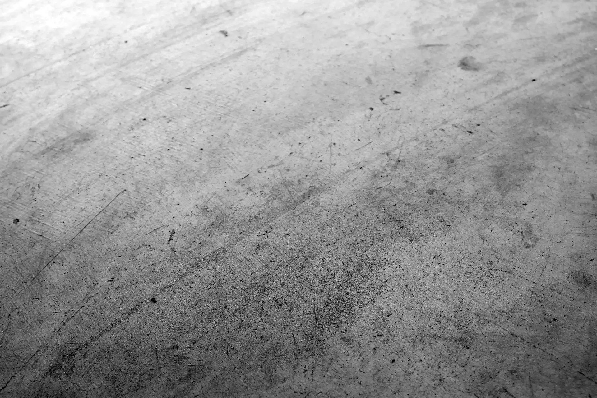 Grayscale close-up of a concrete surface with visible texture and subtle variations in tone.