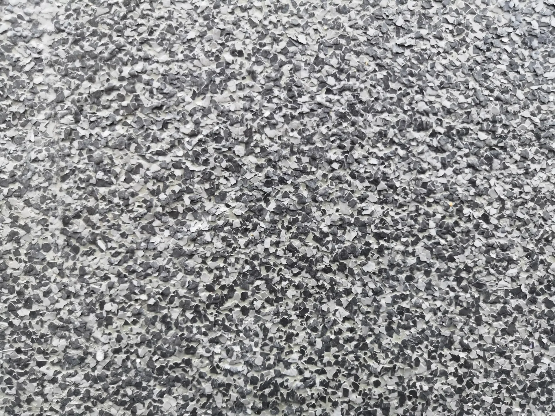 Close-up of a gray and black speckled asphalt surface.