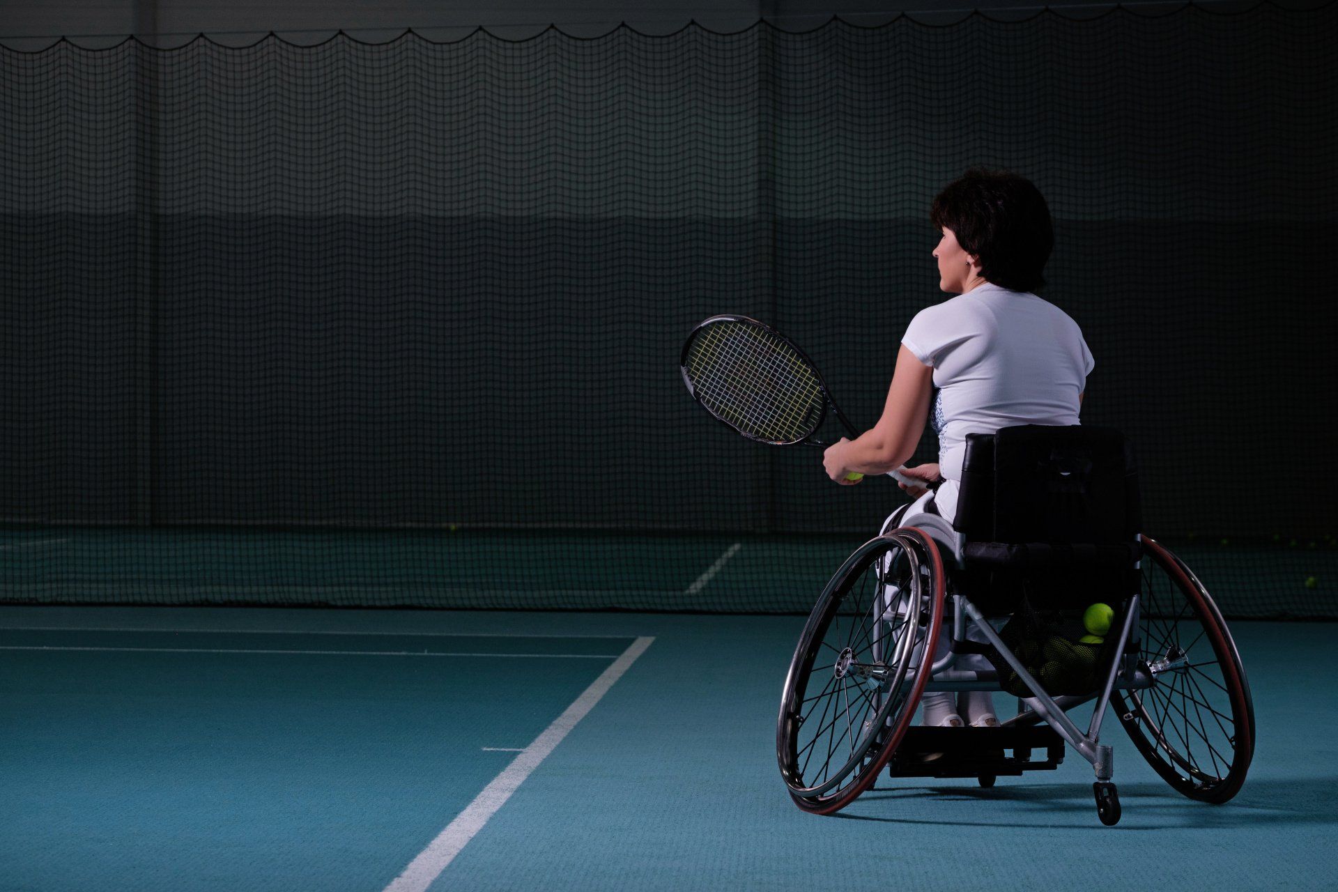 Photo of woman in Wheelchair playing tennis