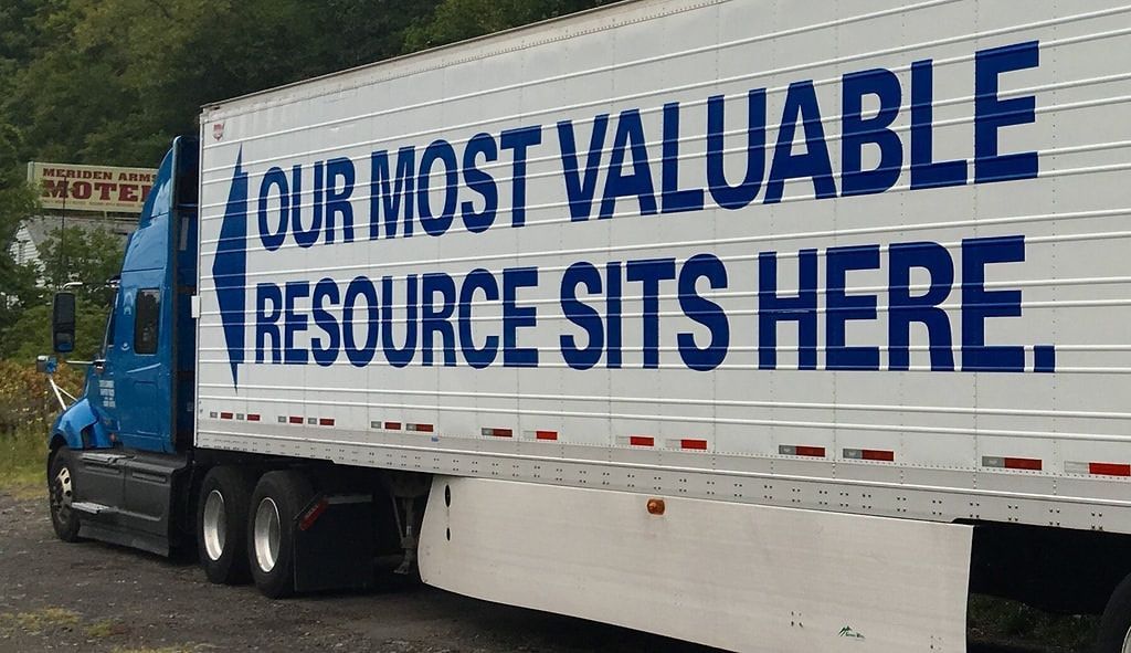 Blue and white semi-truck trailer with the text 