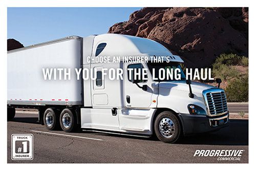 White semi-truck on road; text: