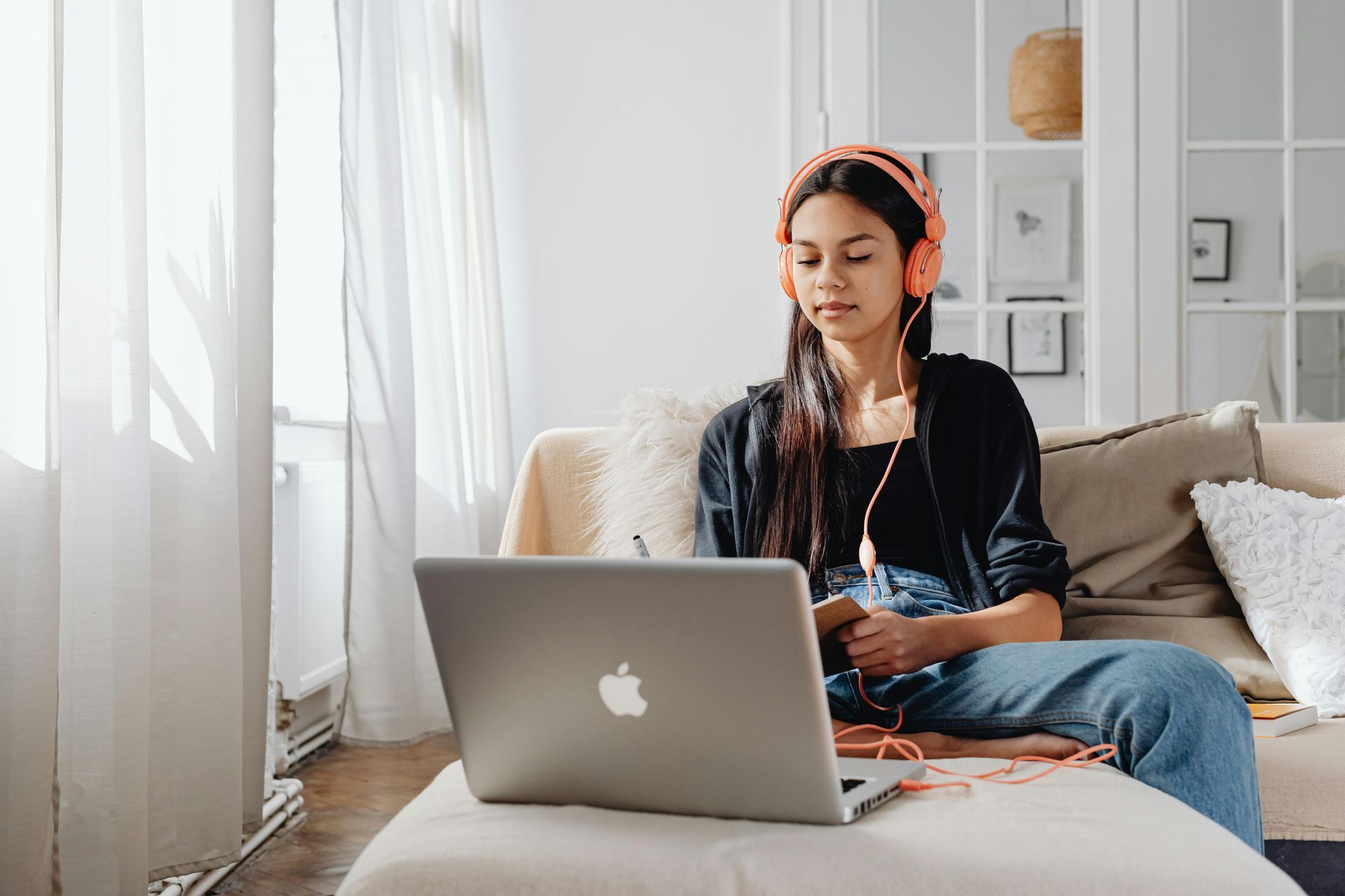 Person with headphones sits on a couch, using Neurofeedback Device