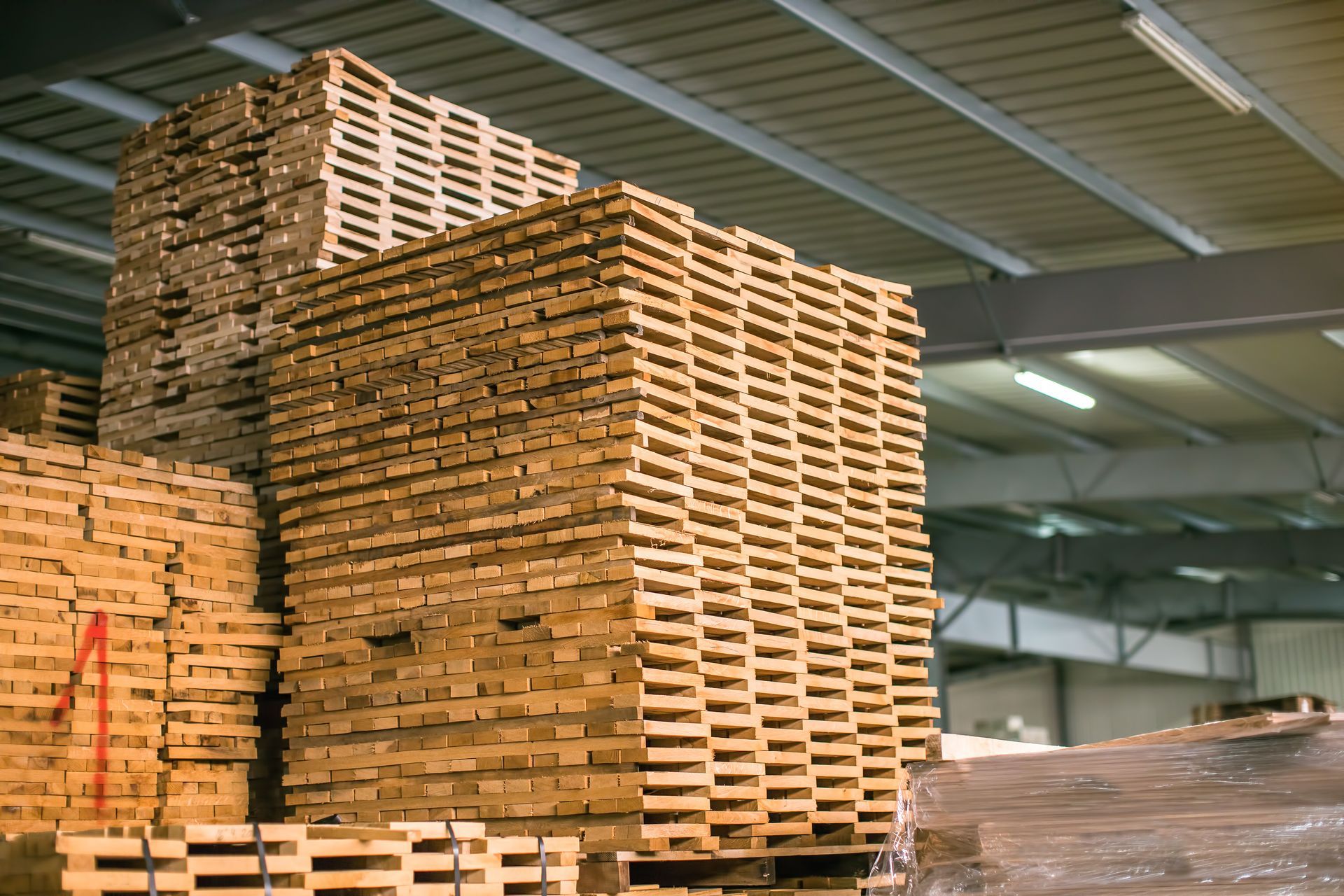 Stacks of wooden pallets in a warehouse storage area