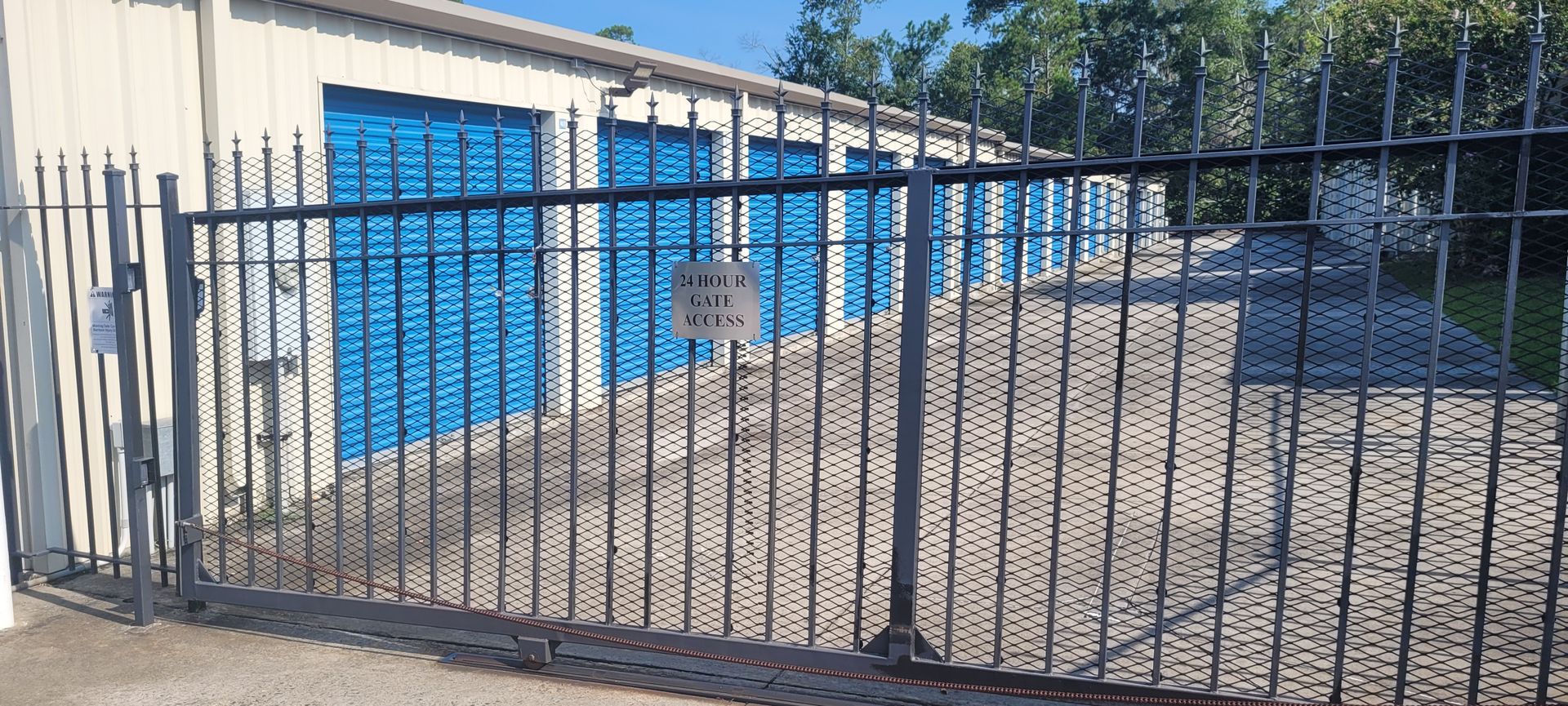 An empty storage room with a garage door open.