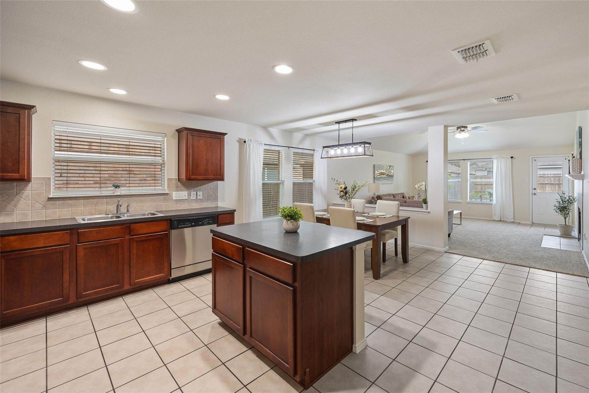 a kitchen with wooden cabinets and stainless steel appliances