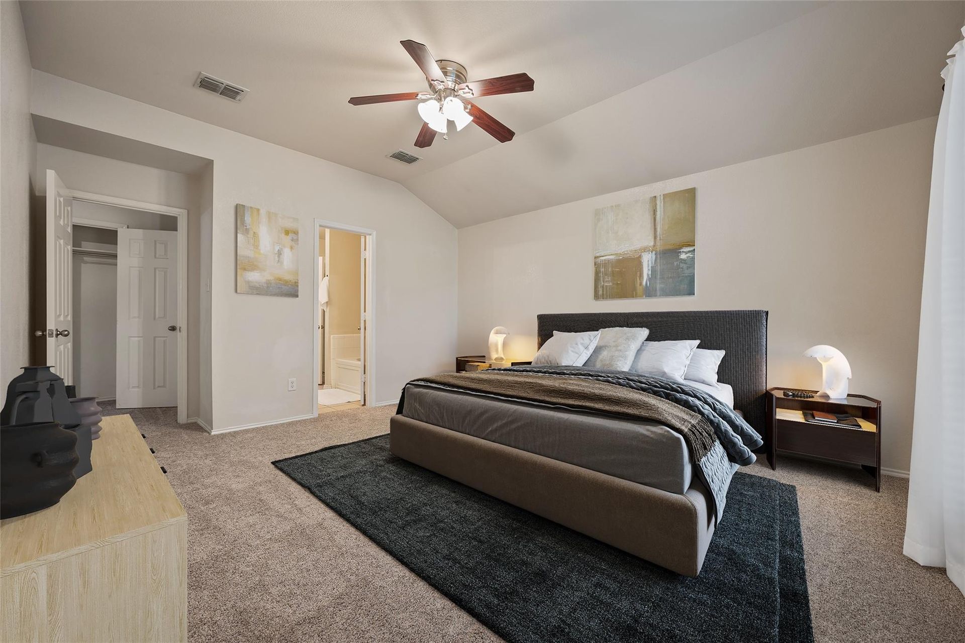 a bedroom with a large bed and a ceiling fan