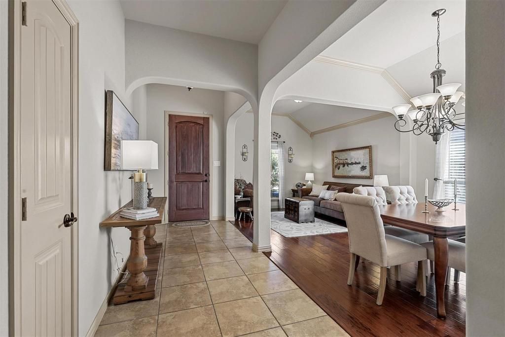 a living room with a couch , chairs , coffee table and television .