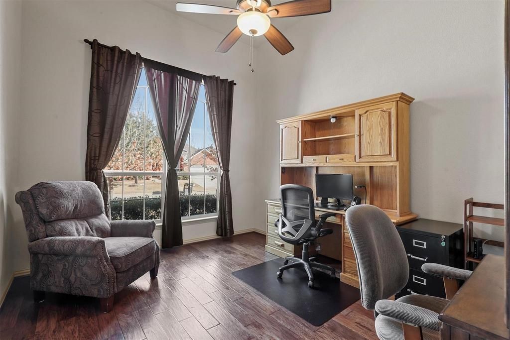 a bedroom with a bed , dresser , nightstand , and ceiling fan .
