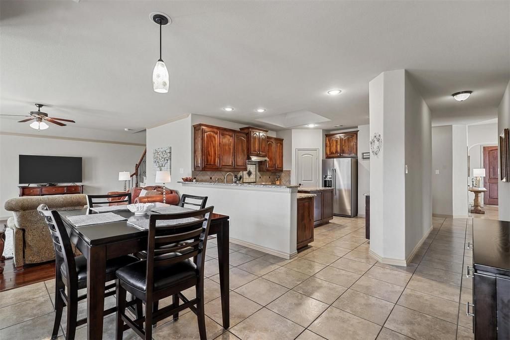 a kitchen with wooden cabinets , granite counter tops , stainless steel appliances and a large island .