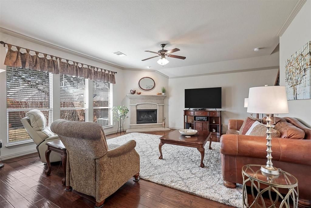 a hallway leading to a living room and dining room in a house .