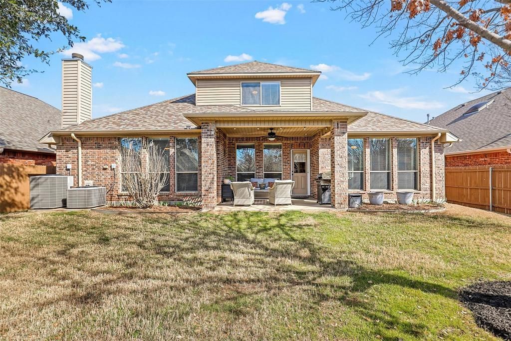 a house with trees in front of it and a walkway leading to it .