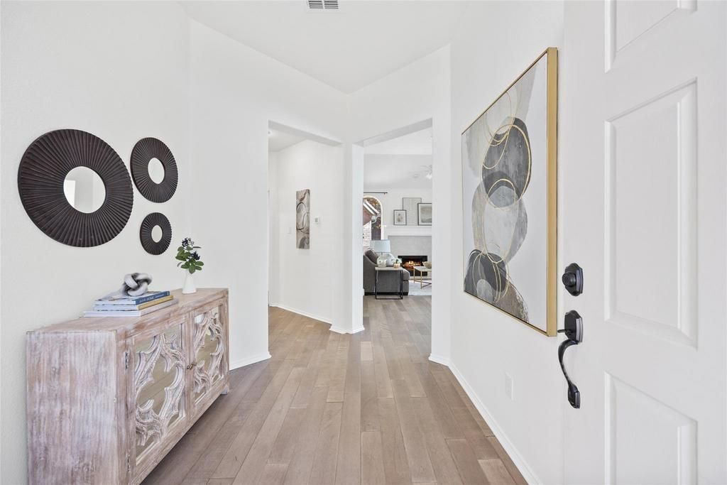 a hallway in a house with a painting on the wall