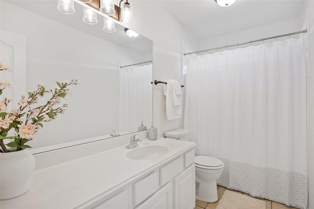 a bathroom with a toilet a sink and a mirror