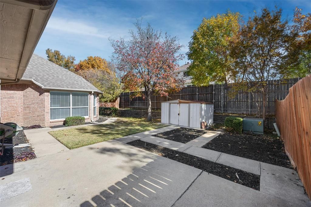 a brick house with a shed in the backyard